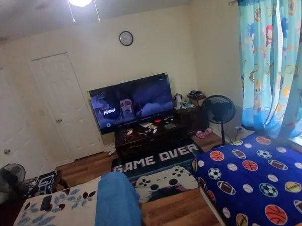 a bedroom with bed and a window