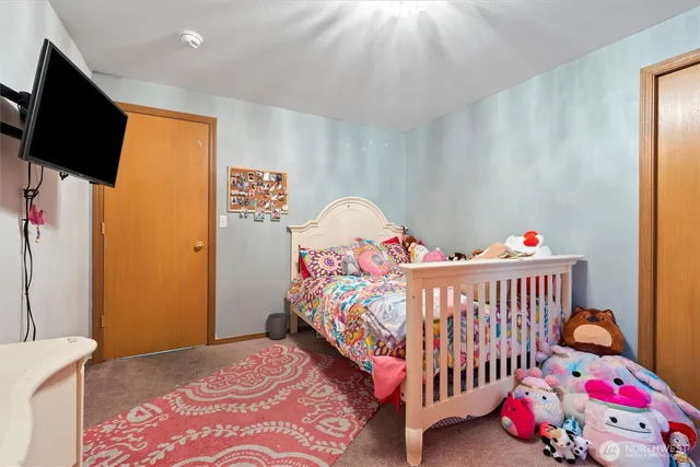a bedroom with bed and a chandelier