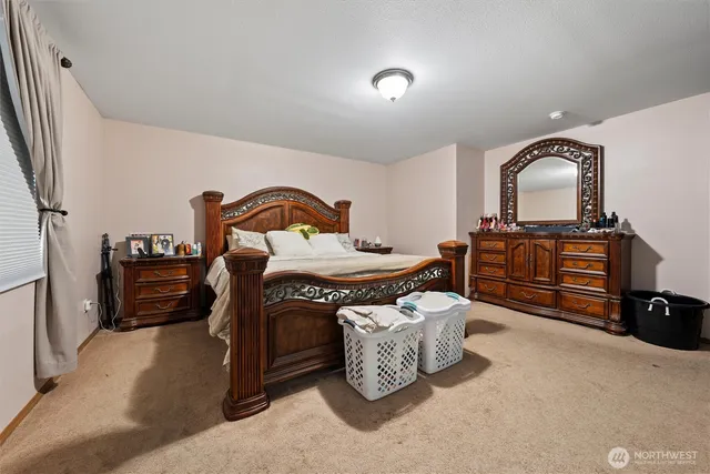 a bedroom with bed and a window