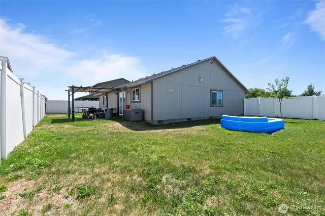 a view of a house with backyard porch and sitting area