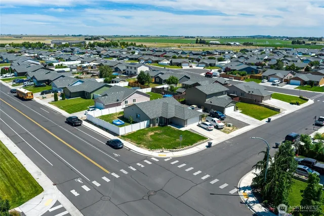 an aerial view of residential houses with outdoor space and street view