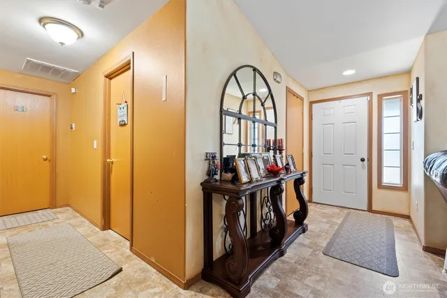 a living room with furniture a flat screen tv and a large window