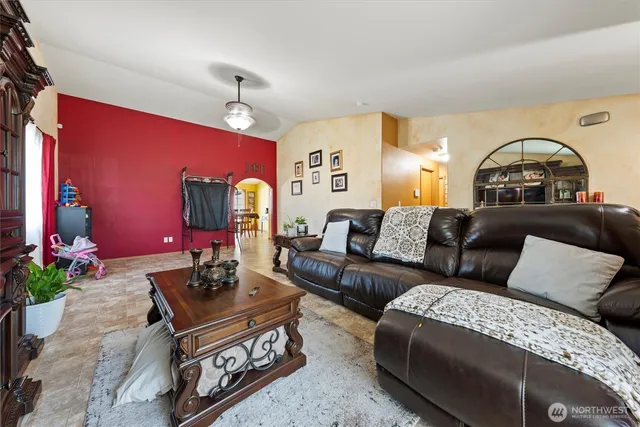 a living room with furniture and a potted plant