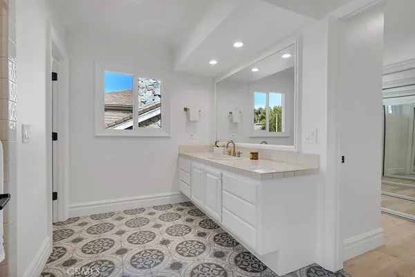 a bathroom with a sink a toilet and mirror