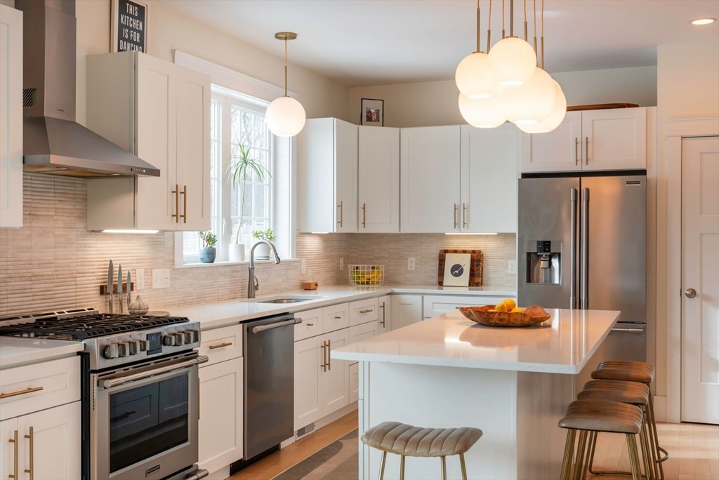 5 John West Road Exeter, NH 03833 - Photo 7 of 33 a kitchen with a sink stainless steel appliances and white cabinets
