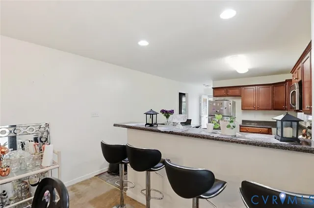 a kitchen with granite countertop counter space chairs cabinets and appliances