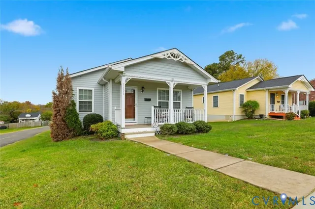 a front view of a house with a yard and porch
