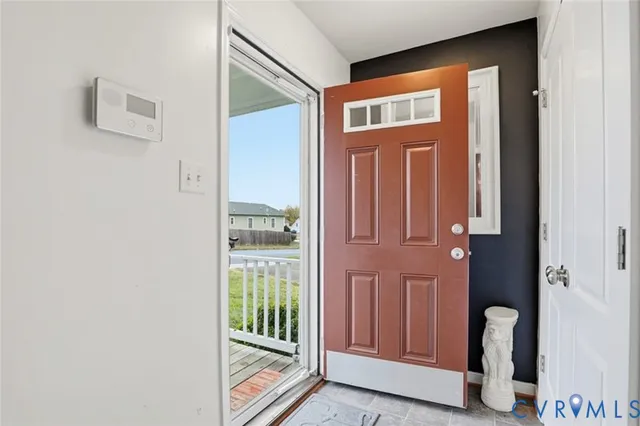 a living room with furniture a flat screen tv and a stove
