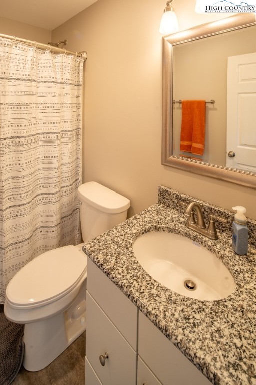 575 Townhomes Place, Unit 34 Boone, NC 28607 - Photo 16 of 32 a bathroom with a granite countertop toilet a sink and mirror