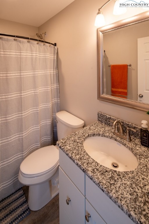 575 Townhomes Place, Unit 34 Boone, NC 28607 - Photo 20 of 32 a bathroom with a granite countertop toilet sink and mirror