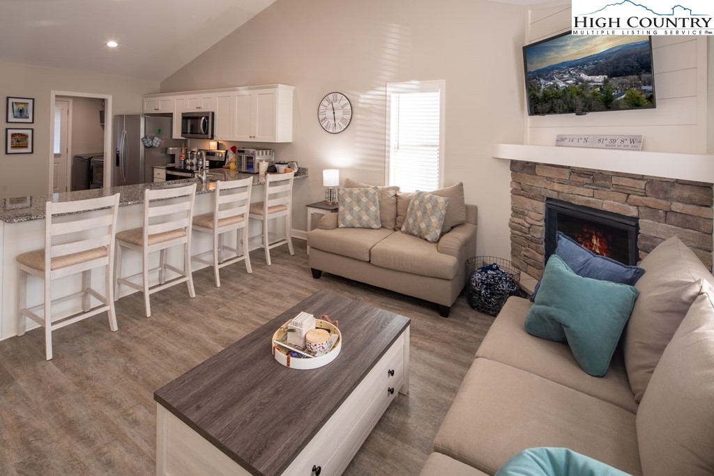 575 Townhomes Place, Unit 34 Boone, NC 28607 - Photo 2 of 32 a living room with furniture a flat screen tv and a fireplace