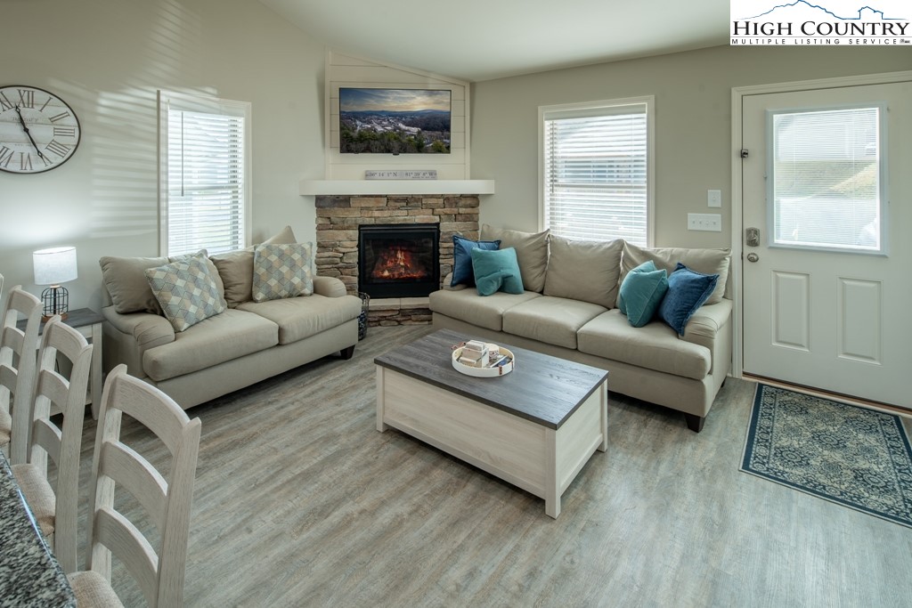 575 Townhomes Place, Unit 34 Boone, NC 28607 - Photo 3 of 32 a living room with furniture a window and a fireplace