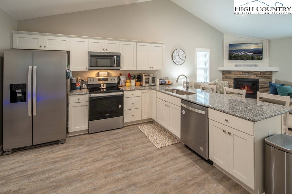 575 Townhomes Place, Unit 34 Boone, NC 28607 - Photo 8 of 32 a kitchen with granite countertop stainless steel appliances and sink