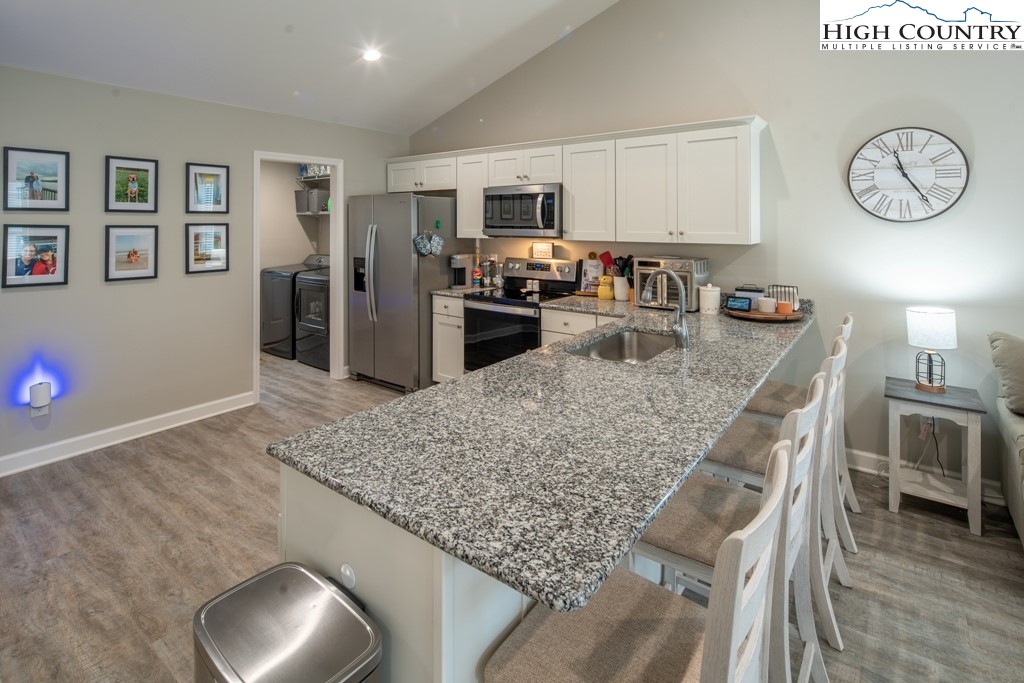 575 Townhomes Place, Unit 34 Boone, NC 28607 - Photo 10 of 32 a kitchen with stainless steel appliances granite countertop a sink refrigerator stove and microwave