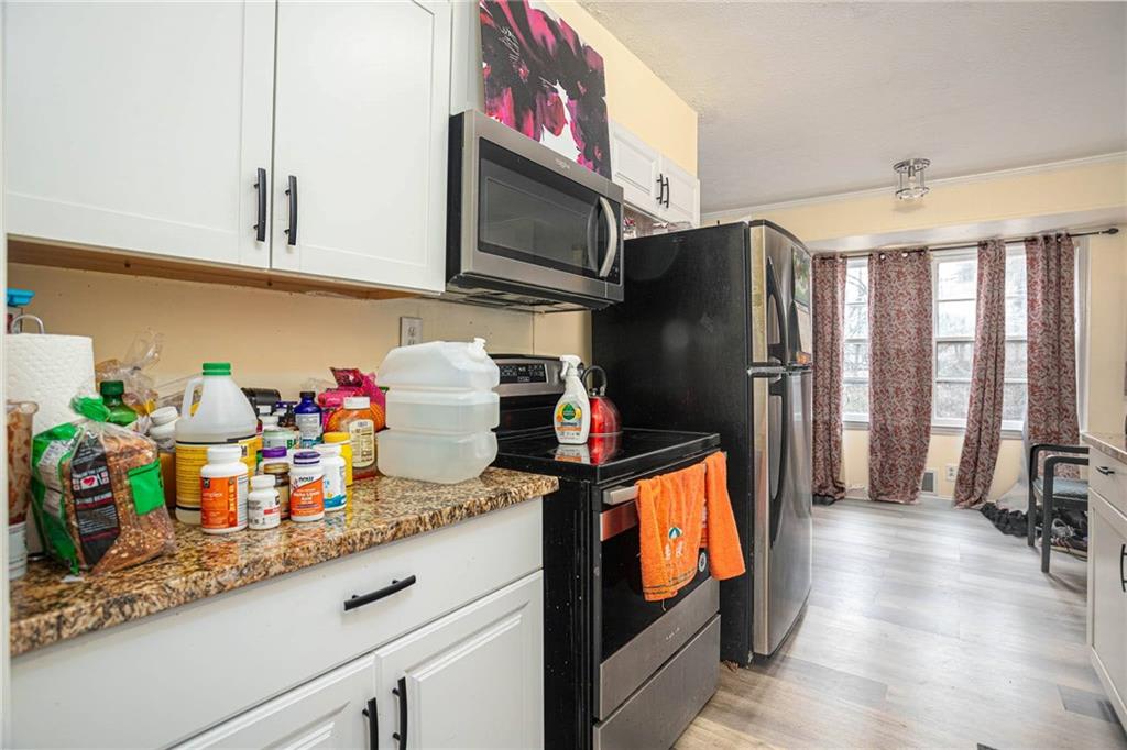 80 Stagecoach Circle Stockbridge, GA 30281 - Photo 14 of 38 a kitchen with stainless steel appliances granite countertop a refrigerator and a sink