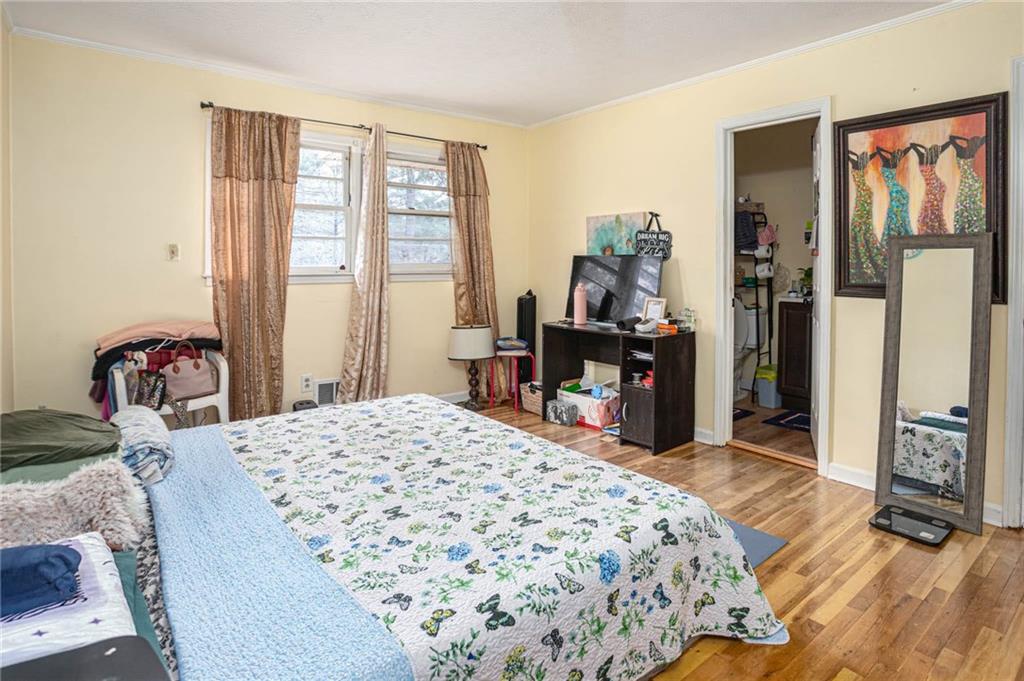 80 Stagecoach Circle Stockbridge, GA 30281 - Photo 22 of 38 a bedroom with a bed and wooden floor