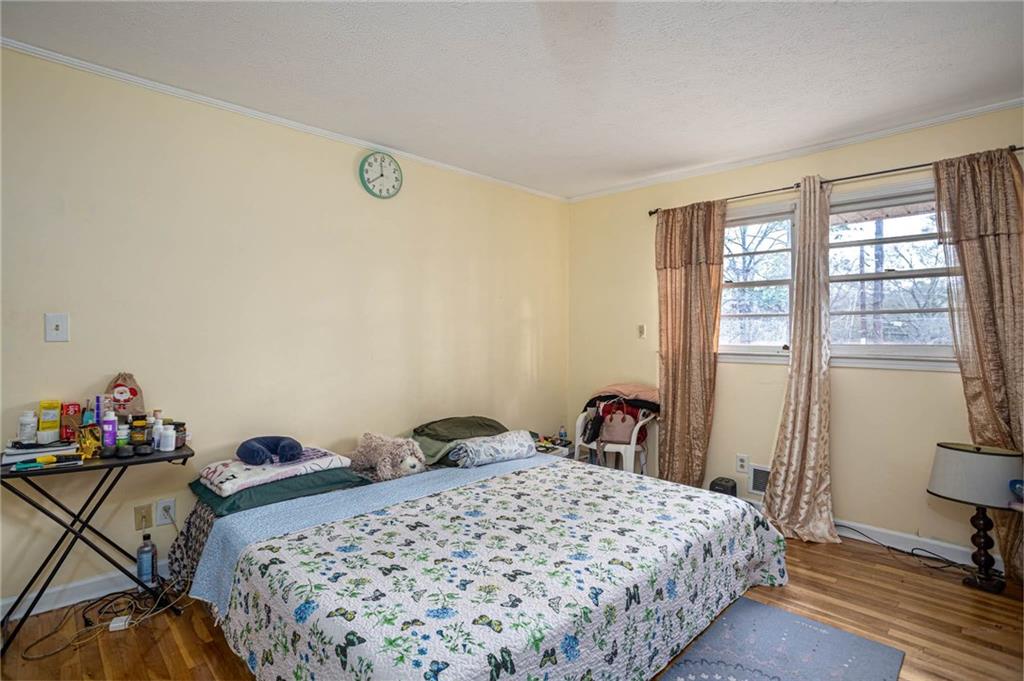 80 Stagecoach Circle Stockbridge, GA 30281 - Photo 23 of 38 a bedroom with a bed and wooden floor