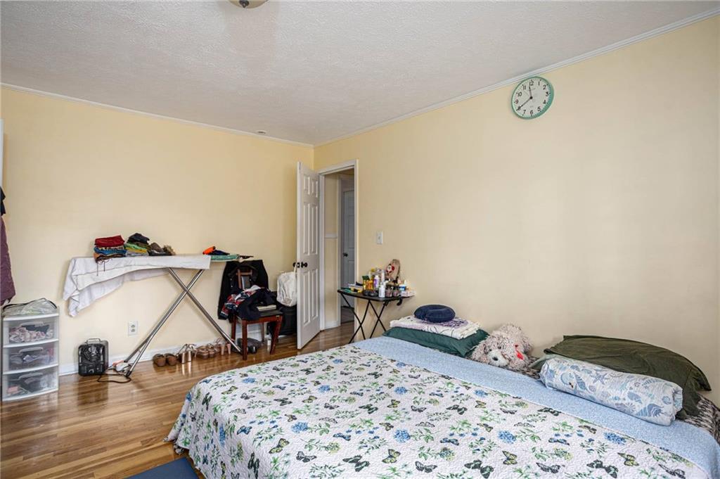 80 Stagecoach Circle Stockbridge, GA 30281 - Photo 24 of 38 a bedroom with a bed and wooden floor