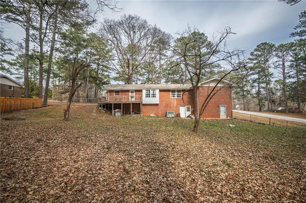 80 Stagecoach Circle Stockbridge, GA 30281 - Photo 36 of 38 a house is sitting in middle of the forest