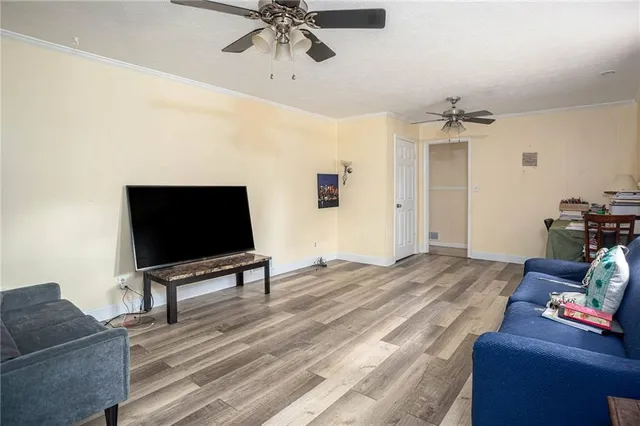 a bedroom with furniture and a flat screen tv