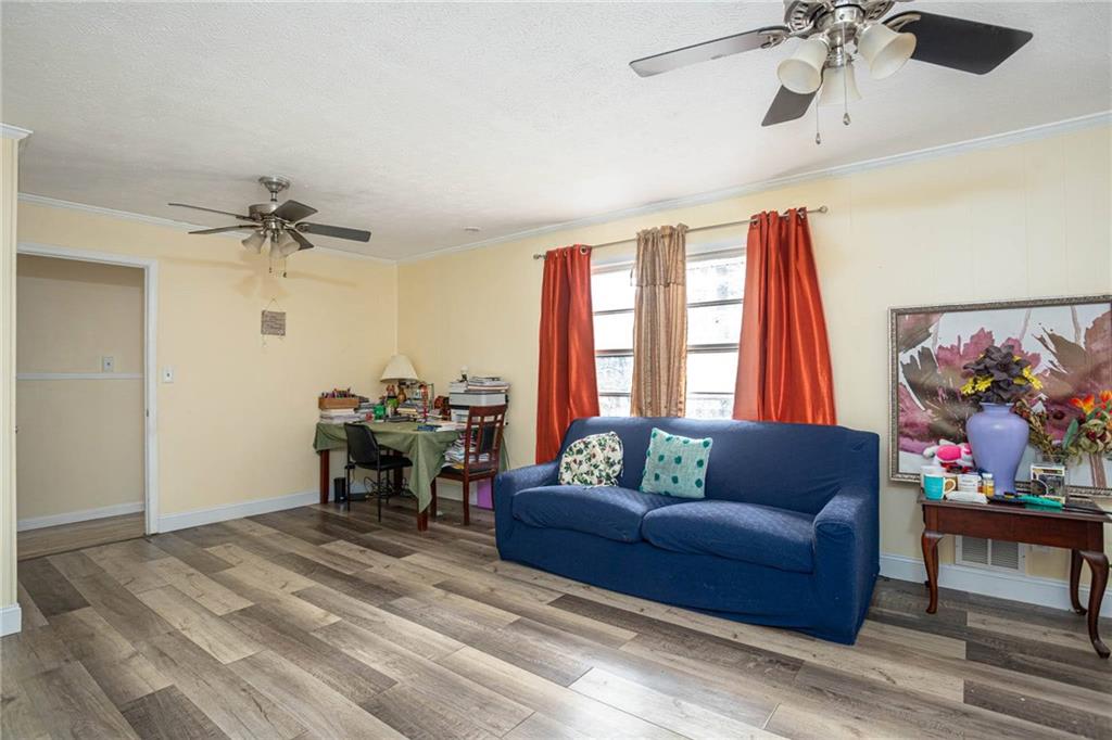 80 Stagecoach Circle Stockbridge, GA 30281 - Photo 10 of 38 a living room with furniture and a chandelier