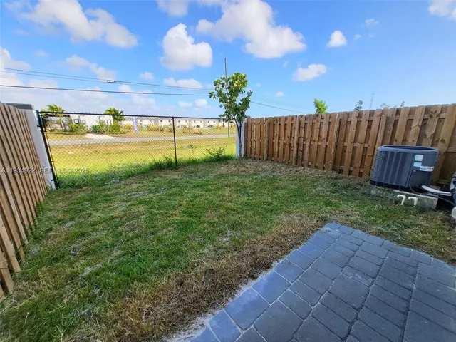 a view of a garden with a building in the background