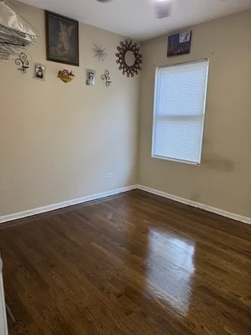 a view of a room with wooden floor and cabinet