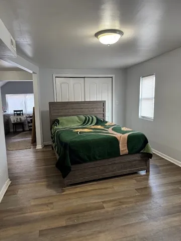 a bedroom with a bed and a view of living room