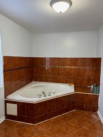 a bathroom with a bathtub and a shower