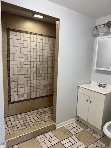 a bathroom with a sink toilet and shower