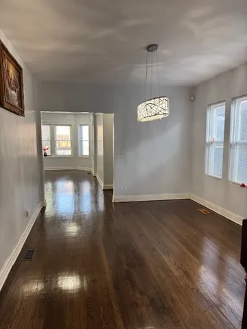 a view of a room with wooden floor and windows