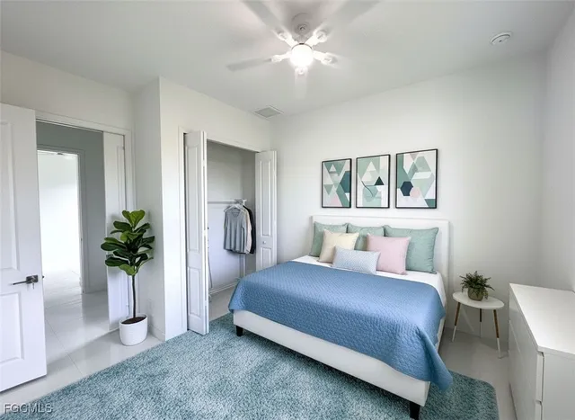 a bedroom with a bed and a potted plant