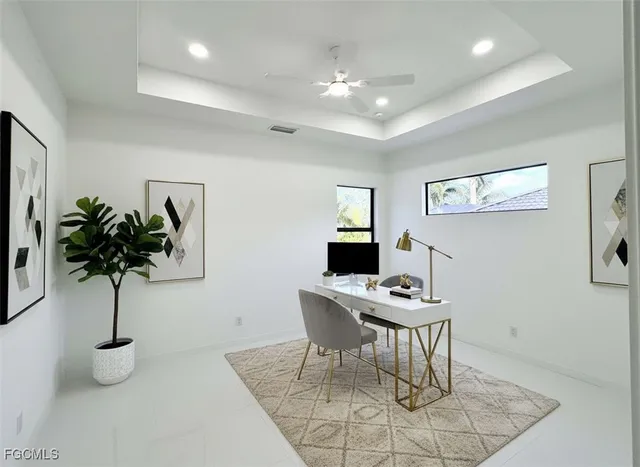 a view of a workspace with furniture and a potted plant