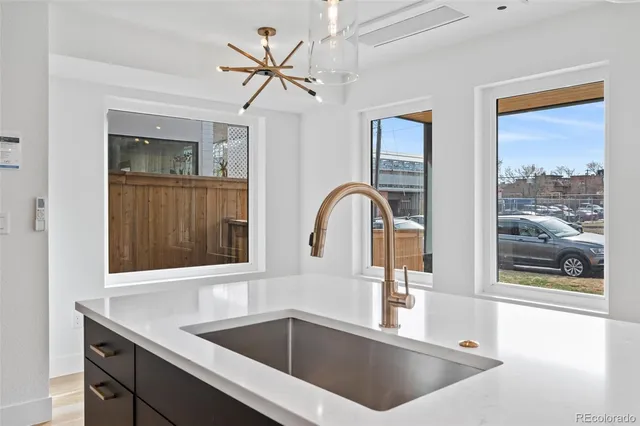 a kitchen with a sink and a large window