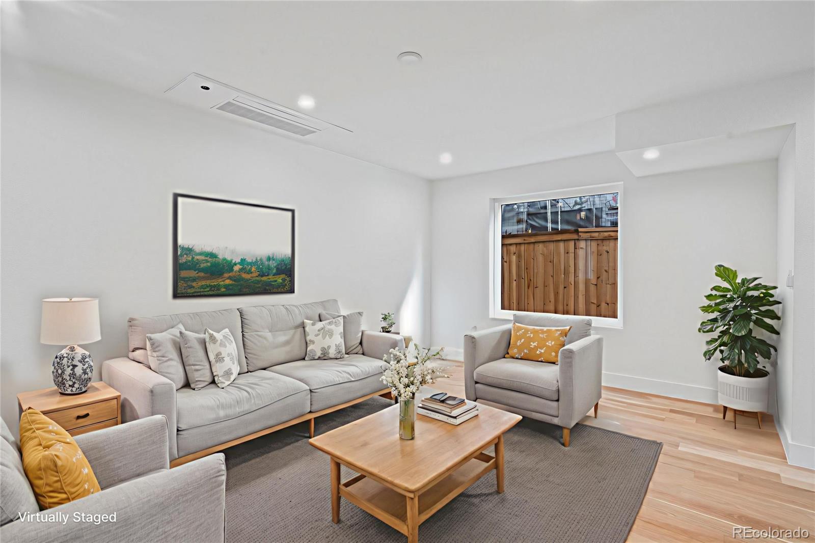 2451 Lawrence Street, Unit 2 Denver, CO 80205 - Photo 2 of 48 a living room with furniture and a potted plant