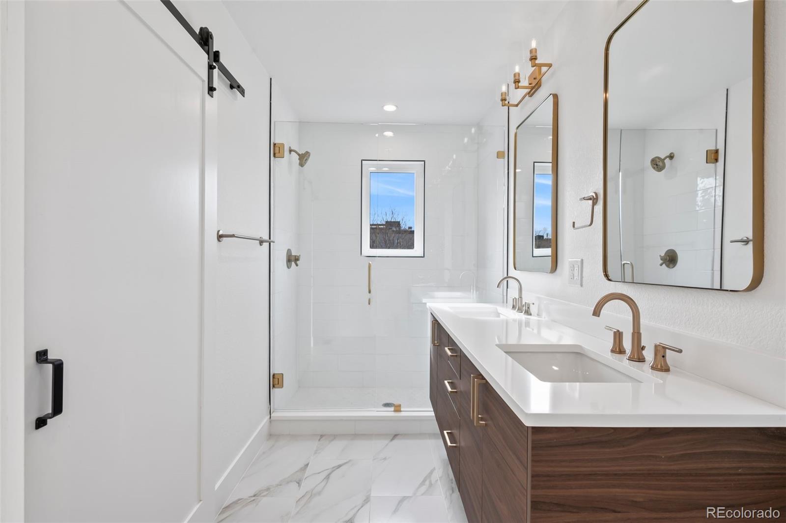2451 Lawrence Street, Unit 2 Denver, CO 80205 - Photo 23 of 48 a bathroom with a sink and a mirror