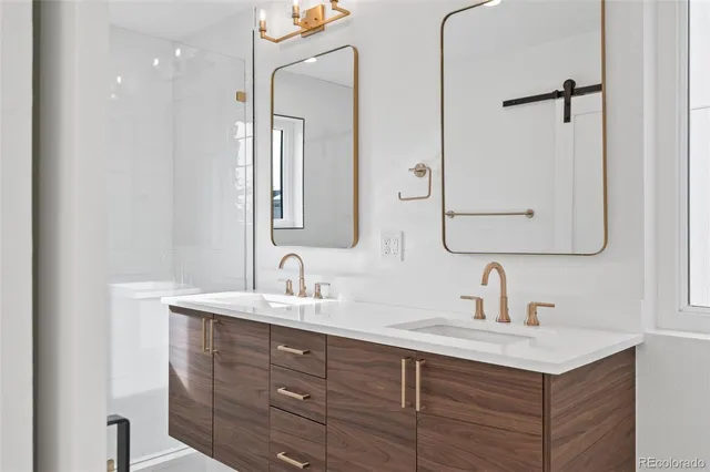 a bathroom with a double vanity sink mirror and