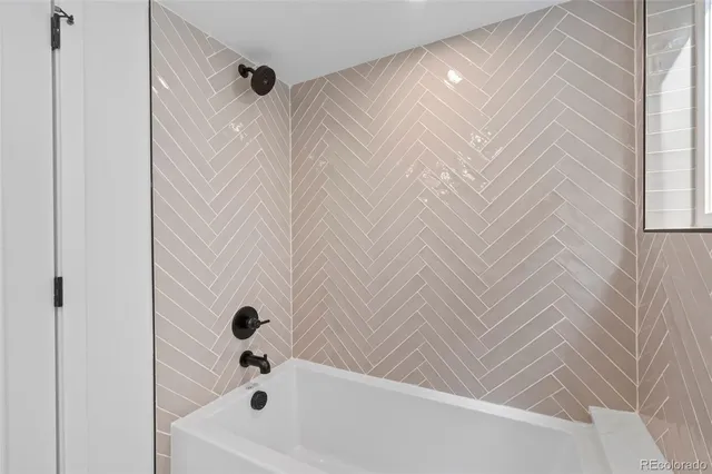 a large white kitchen with sink and mirror