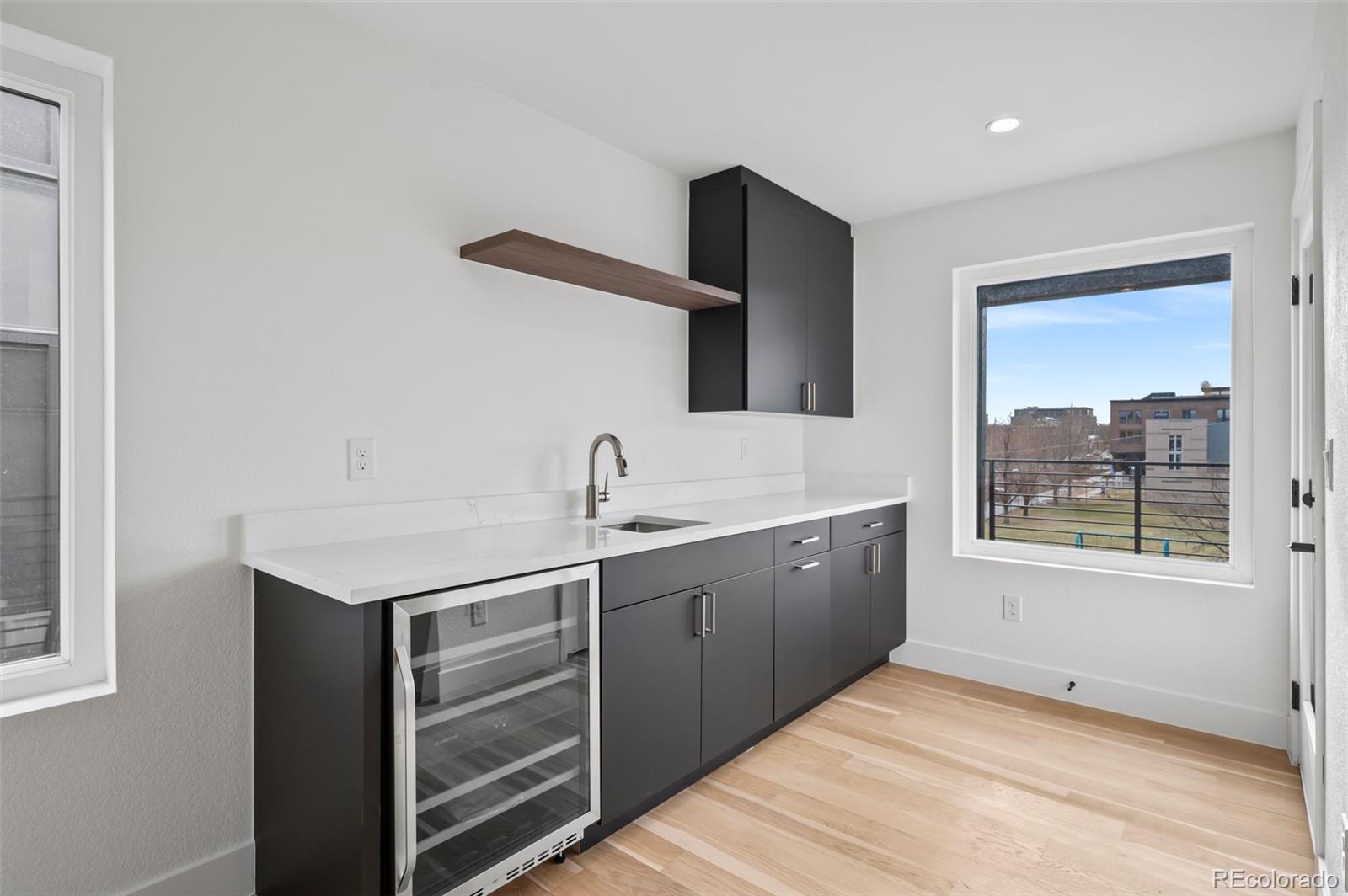 2451 Lawrence Street, Unit 2 Denver, CO 80205 - Photo 30 of 48 a kitchen with a sink cabinets and window
