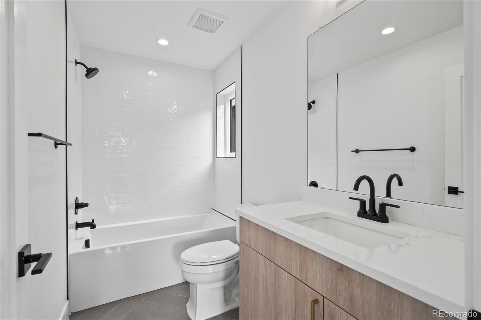 2451 Lawrence Street, Unit 2 Denver, CO 80205 - Photo 35 of 48 a bathroom with a sink a toilet and shower
