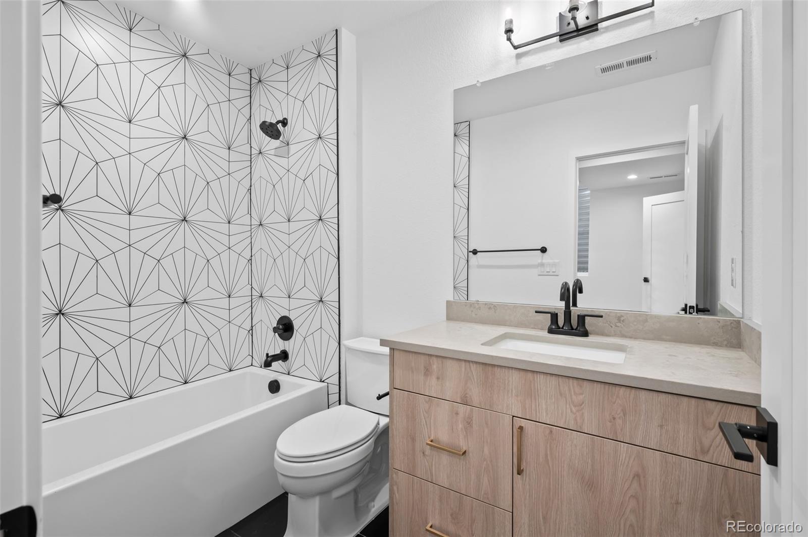 2451 Lawrence Street, Unit 2 Denver, CO 80205 - Photo 41 of 48 a bathroom with a sink a toilet and a bathtub