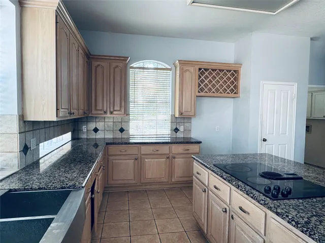 a kitchen with stainless steel appliances granite countertop a sink stove and cabinets
