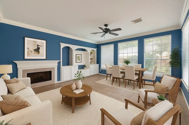 a living room with furniture a fireplace and a large window