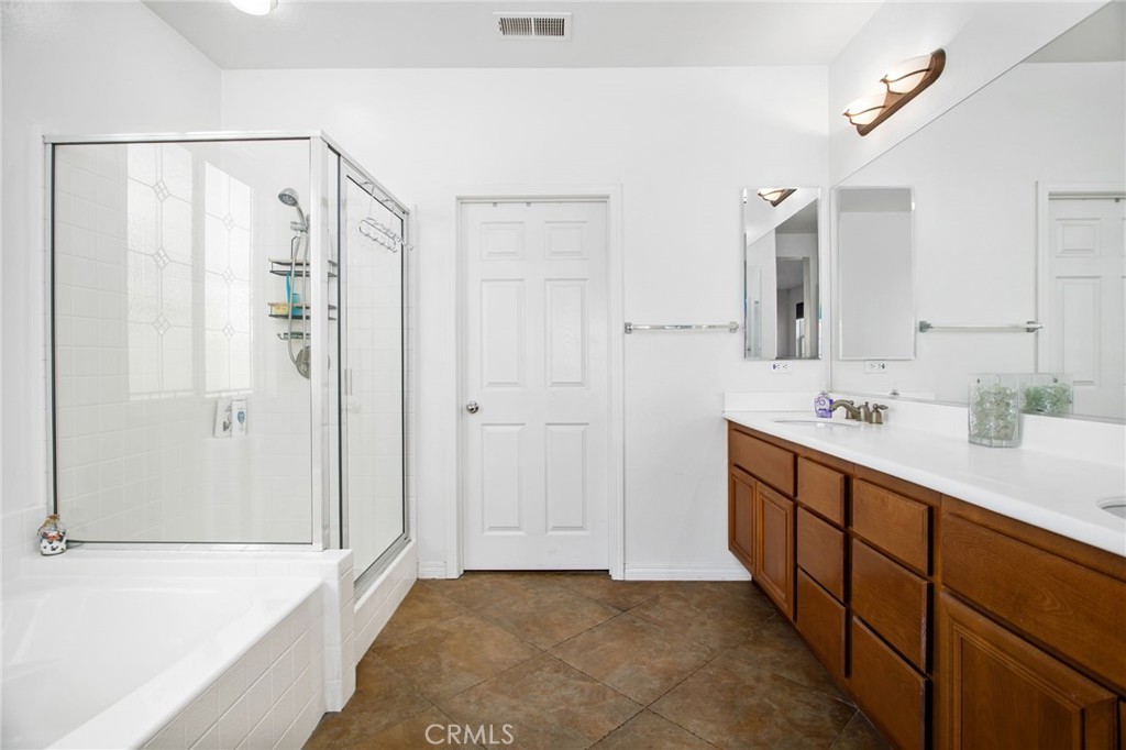 31677 Middlebrook Lane Menifee, CA 92584 - Photo 19 of 42 a spacious bathroom with a shower and a sink