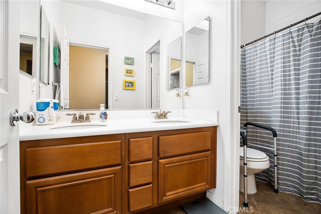 31677 Middlebrook Lane Menifee, CA 92584 - Photo 23 of 42 a bathroom with a sink a toilet and shower