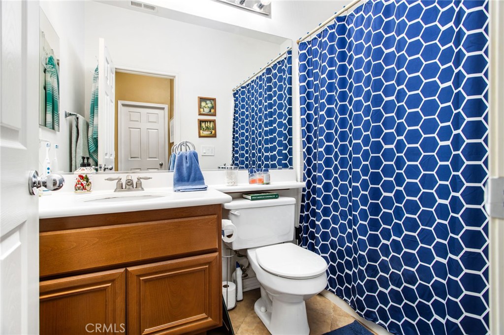 31677 Middlebrook Lane Menifee, CA 92584 - Photo 26 of 42 a bathroom with a sink toilet and shower