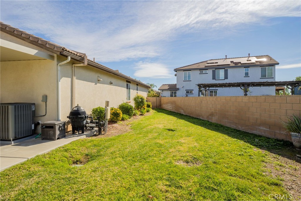 31677 Middlebrook Lane Menifee, CA 92584 - Photo 31 of 42 a view of a swimming pool with a chair and tables in the patio
