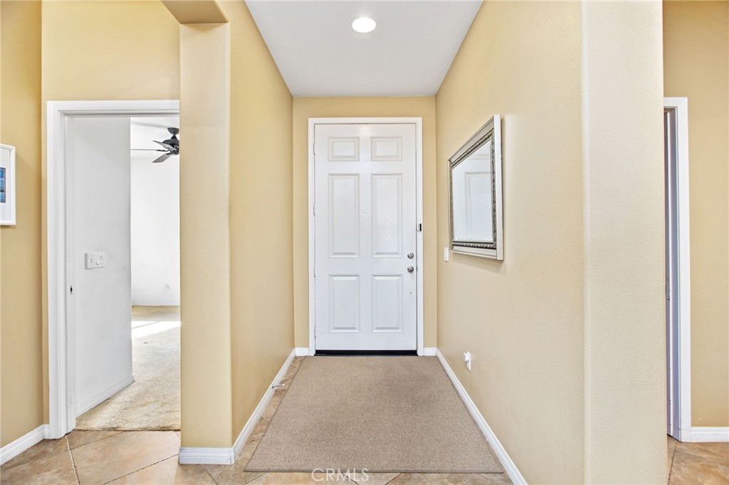 31677 Middlebrook Lane Menifee, CA 92584 - Photo 6 of 42 a view of a hallway with wooden floor and closet