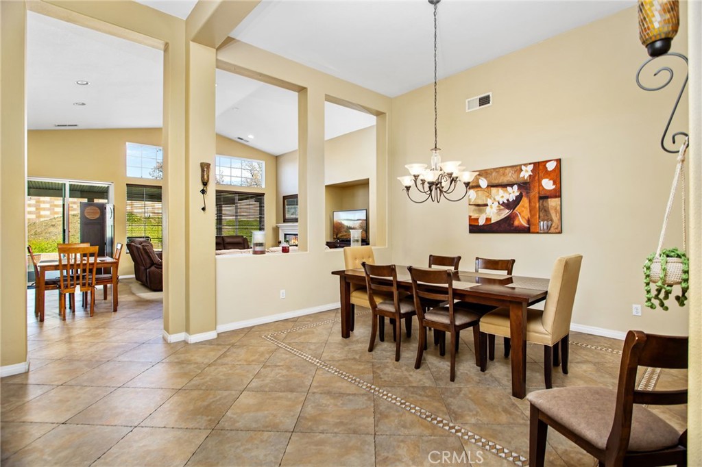 31677 Middlebrook Lane Menifee, CA 92584 - Photo 7 of 42 a view of a dining room with furniture and chandelier
