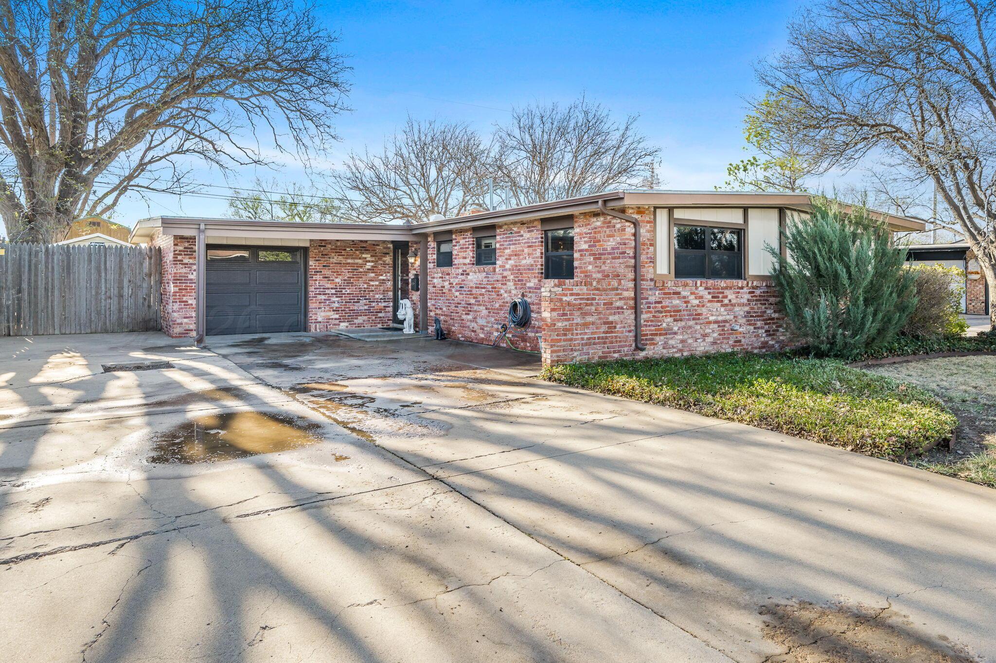 3603 Hancock Street Amarillo, TX 79109 - Photo 1 of 23 a front view of a house with a yard and garage